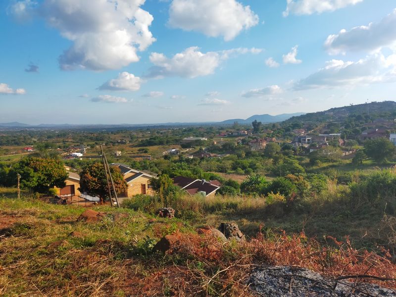 A scenic elevated view overlooking a residential neighborhood and surrounding landscape, showcasing the natural terrain and local area.