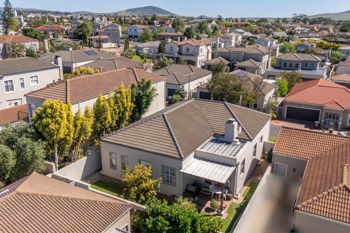 Aerial view of the property showing the roof structure, rear patio area, and surrounding residential neighbourhood.