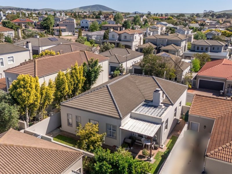 Aerial view of the property showing the roof structure, rear patio area, and surrounding residential neighbourhood.