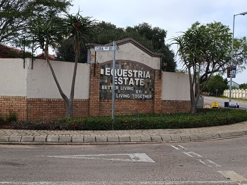 Street view of the Equestria Estate entrance featuring perimeter walling and estate signage.