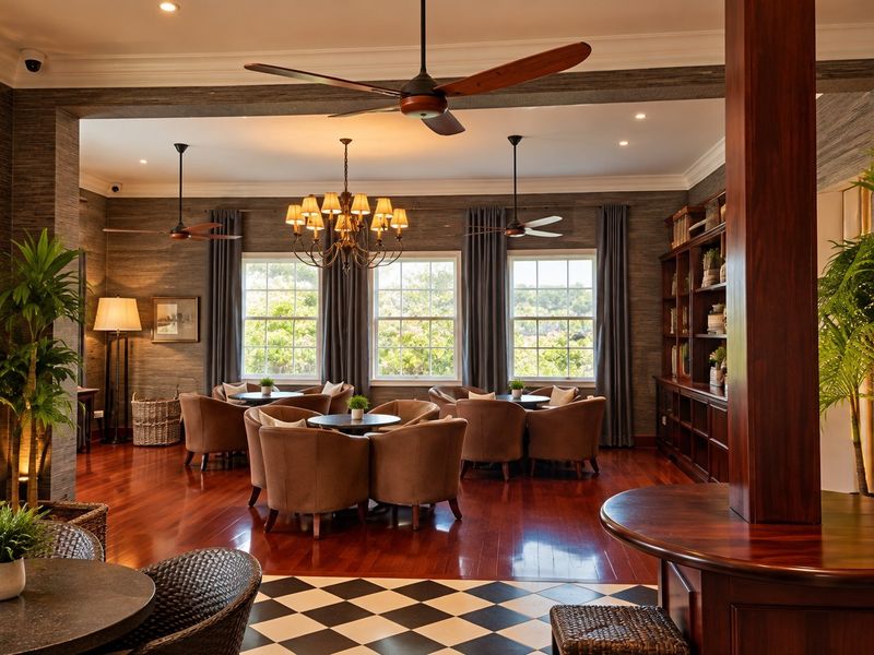 Elegant living area featuring rich hardwood flooring, classic crown molding, built-in shelving, and sophisticated lighting fixtures, creating a warm and inviting atmosphere.