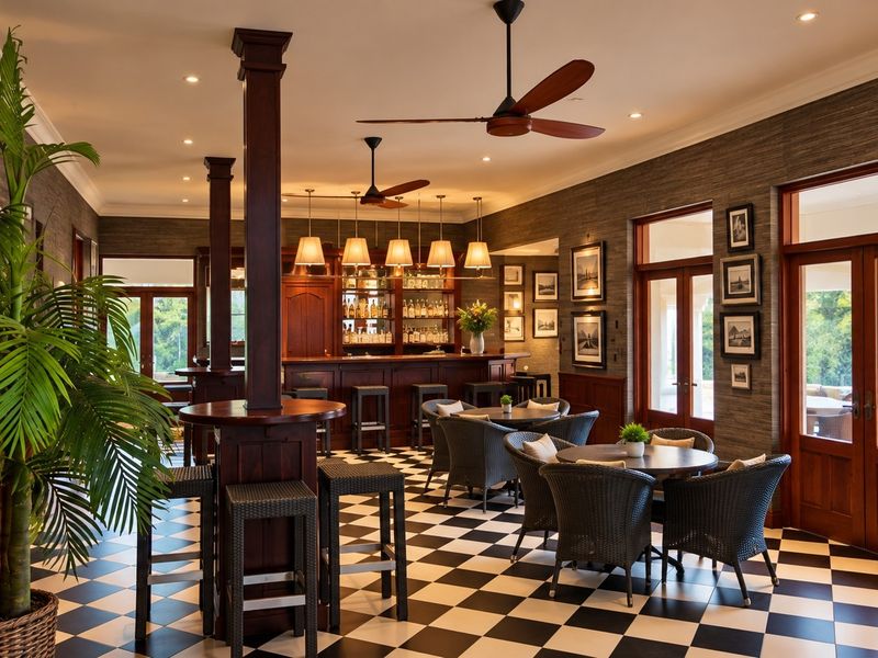 A sophisticated, well-appointed bar area featuring a built-in counter, classic checkered flooring, timber accents, and elegant ceiling fans.