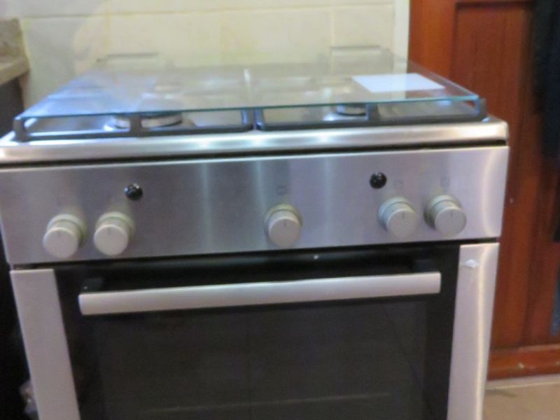 A stainless steel Bosch gas stove and oven unit positioned against a tiled kitchen splashback.