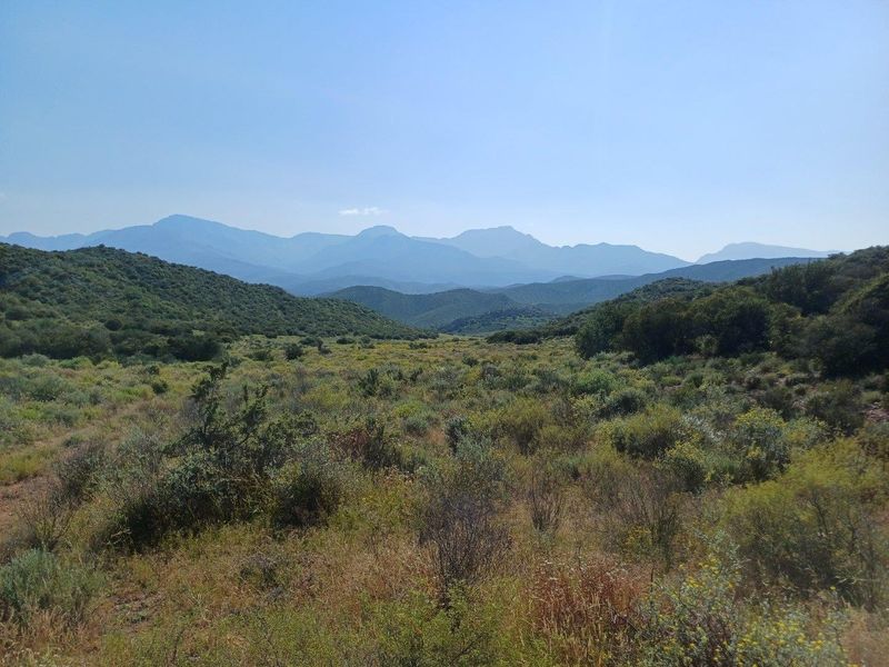 Expansive scenic view of the surrounding natural landscape and mountain range, showcasing the property's rural setting.
