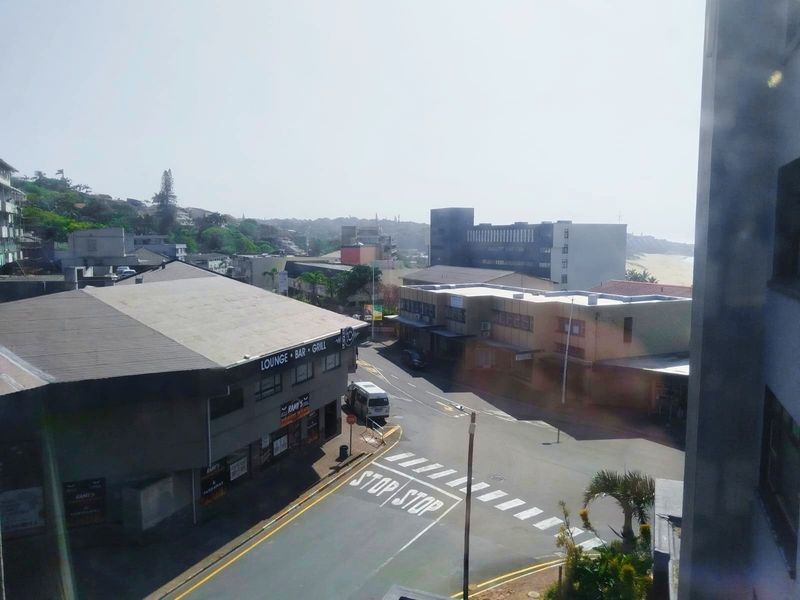 Elevated street view overlooking the surrounding neighbourhood and local commercial buildings.