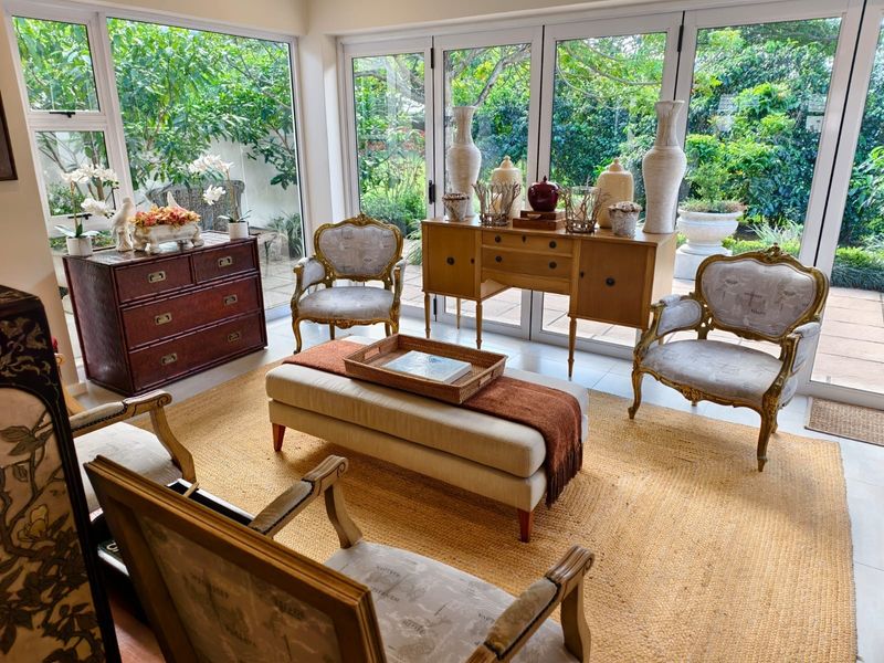 Bright living area featuring large glass sliding doors that provide seamless access to the garden and abundant natural light.