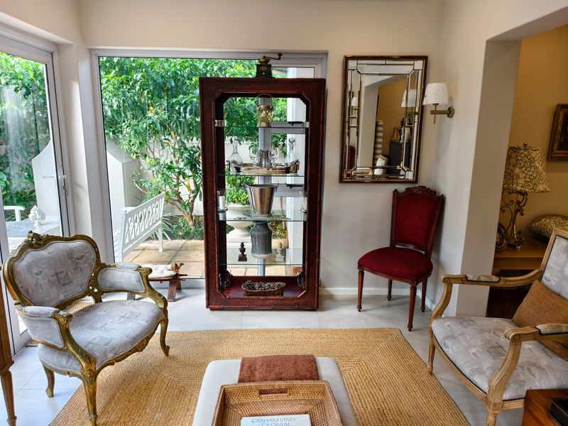 A bright living area featuring large sliding glass doors that provide natural light and direct access to the outdoor garden space.