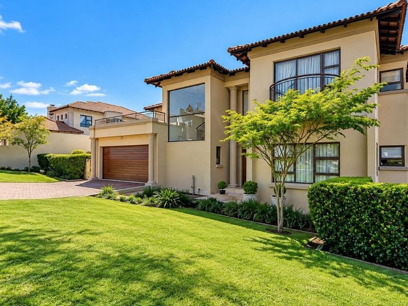A well-maintained double-story residential property featuring a paved driveway, landscaped front garden, and a secure garage.