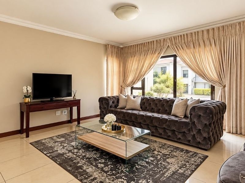 A well-maintained living room featuring neutral tiled flooring, classic ceiling cornicing, and large windows that provide ample natural light.