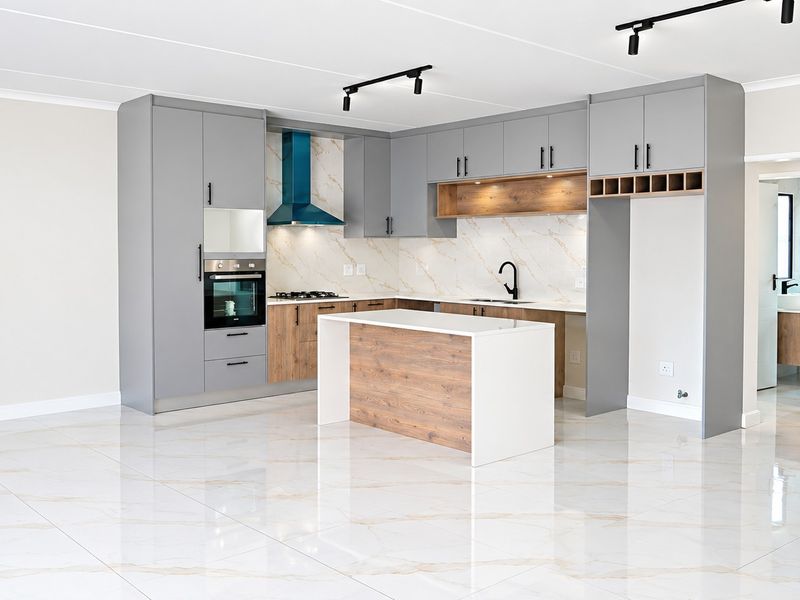 Modern open-plan kitchen featuring grey and wood-tone cabinetry, stone countertops, built-in oven, gas hob, and high-gloss marble-look floor tiles.