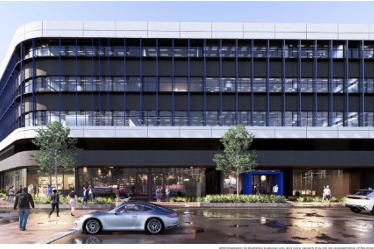 A modern multi-story office building featuring a contemporary facade with extensive glazing, architectural fins, and a prominent ground-level commercial entrance.