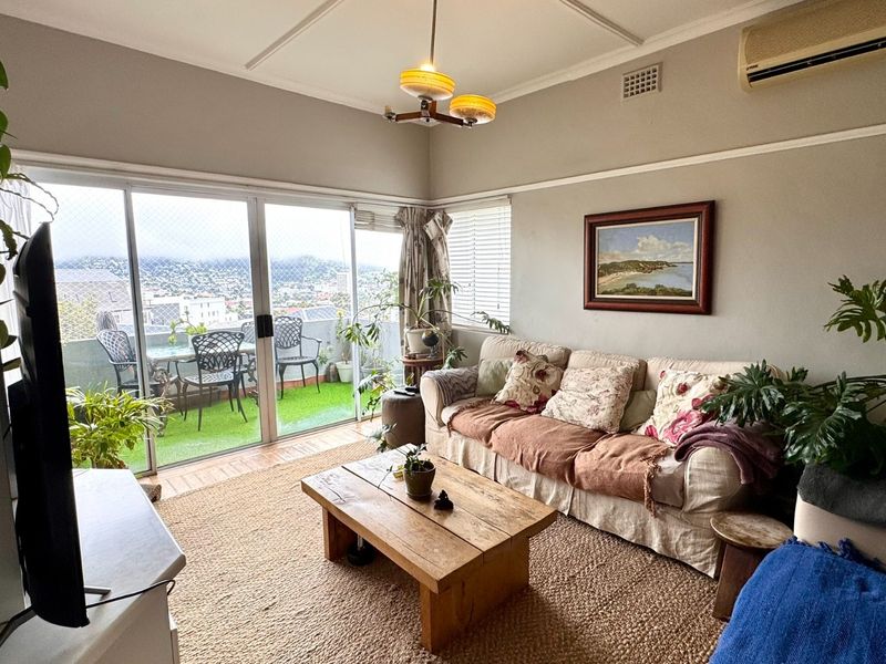 A comfortable living room featuring sliding glass doors that open onto a balcony, providing natural light and views.