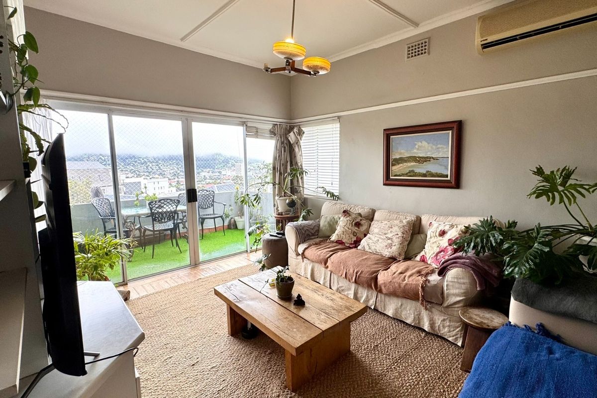 A comfortable living room featuring sliding glass doors that open onto a balcony, providing natural light and views.