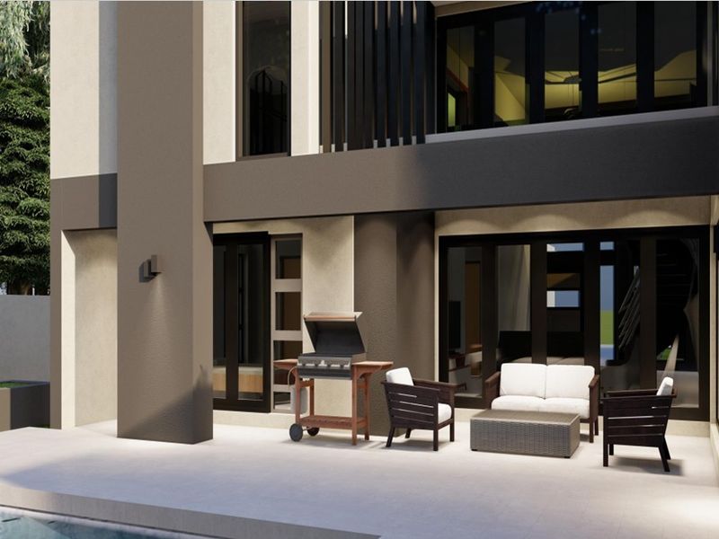 A modern covered patio area featuring large sliding glass doors, recessed wall lighting, and a clean concrete finish, overlooking the pool area.