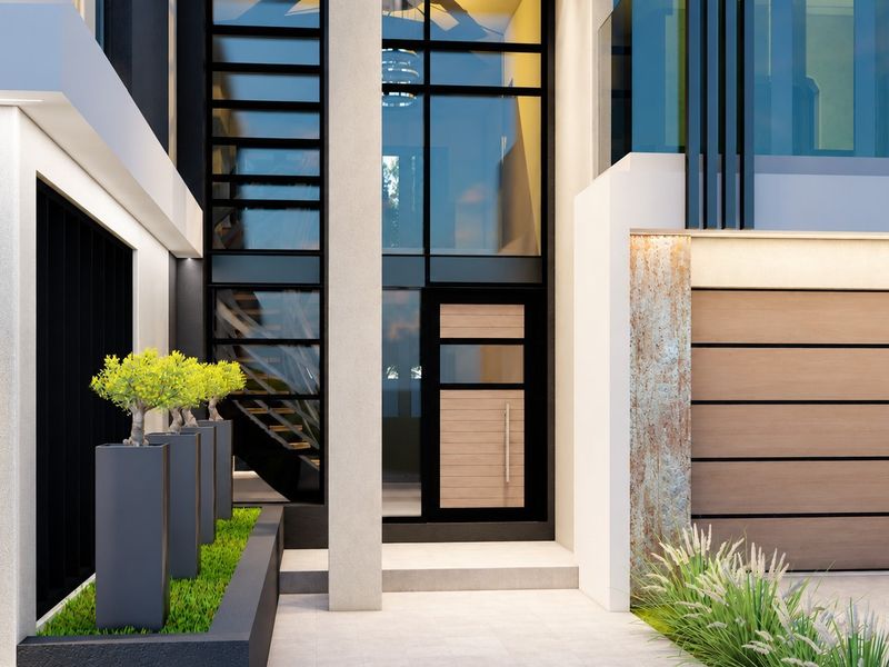 A modern front entrance featuring a contemporary door, floor-to-ceiling glass windows, stone cladding, and integrated planter boxes.