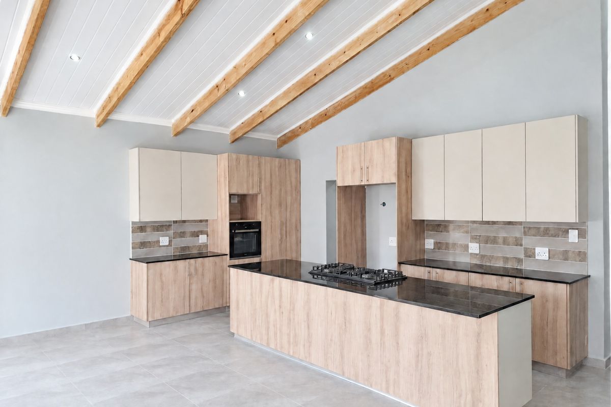Modern kitchen featuring a large island with a gas hob, built-in oven, light wood cabinetry, tiled backsplash, and striking exposed timber ceiling beams.