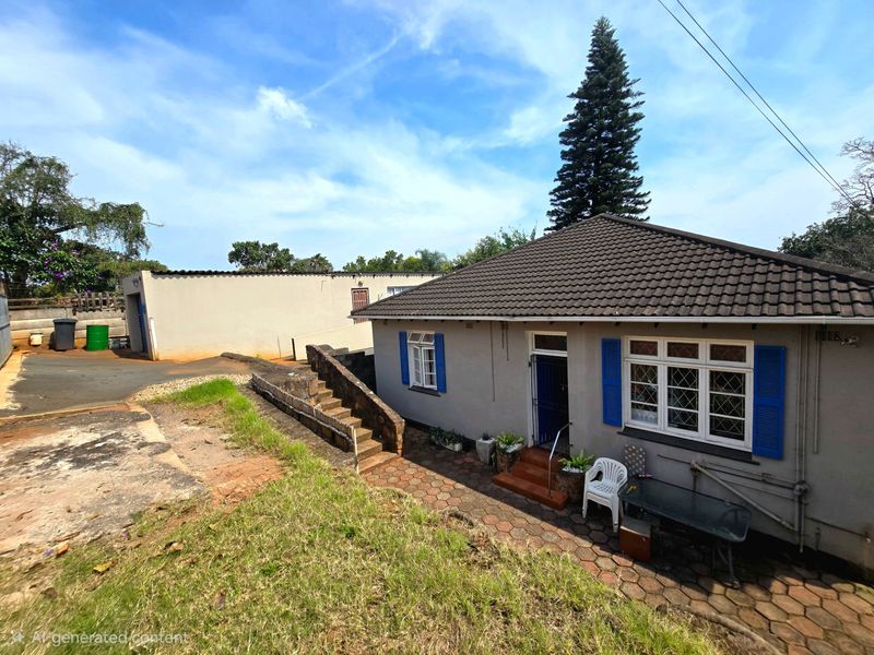 A single-story residential property featuring a tiled roof, blue shutters, and a paved entrance area with stone retaining walls and a concrete driveway.