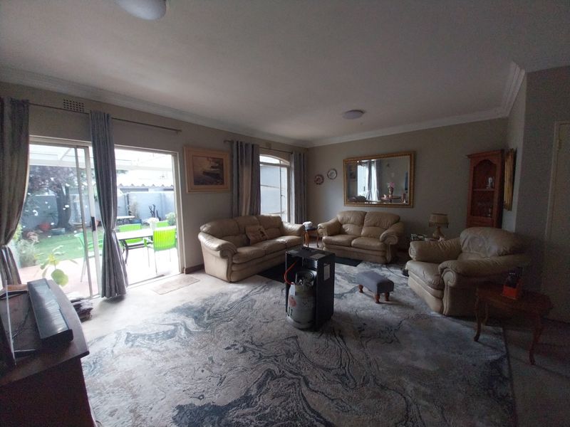 Spacious living room featuring large sliding glass doors that provide natural light and direct access to the outdoor patio area.