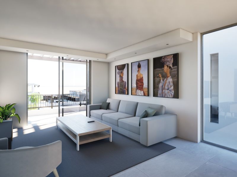 Modern living room featuring recessed ceiling lighting, large sliding glass doors leading to a balcony, and neutral tiled flooring.