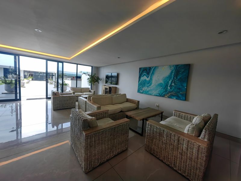 Spacious living area featuring large sliding glass doors that provide ample natural light and seamless access to the outdoor patio space.