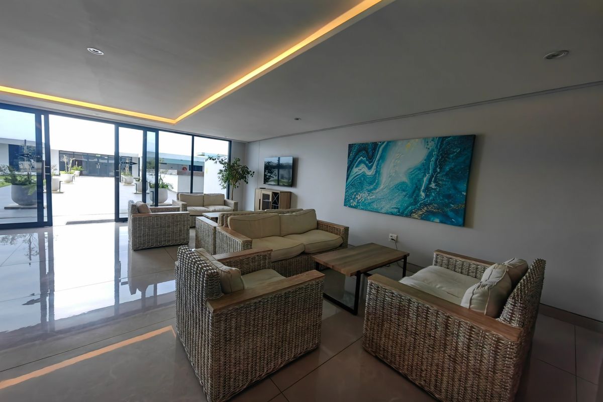Spacious living area featuring large sliding glass doors that provide ample natural light and seamless access to the outdoor patio space.