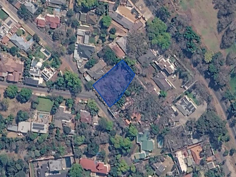 An aerial view showing the vacant residential land plot highlighted within an established suburban neighborhood.