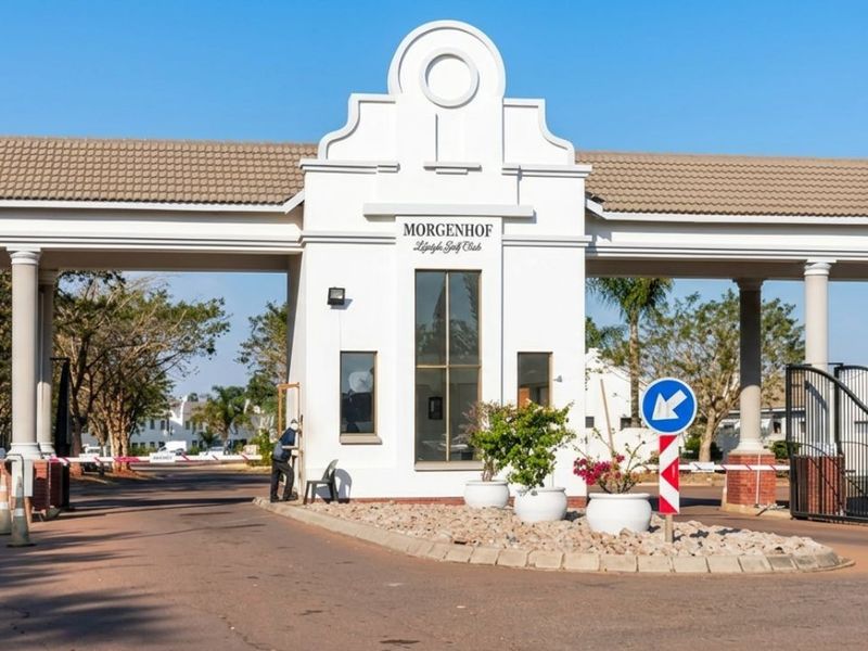 The main entrance gatehouse of the Morgenhof Lifestyle Golf Club, featuring a secure access point with boom gates and architectural columns.
