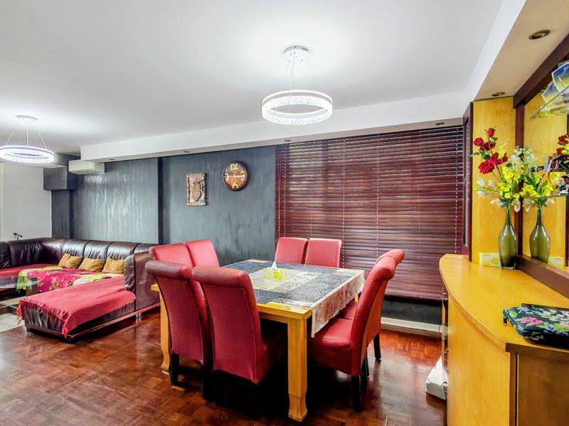 Spacious open-plan living and dining area featuring rich parquet flooring, modern pendant lighting, and built-in cabinetry, creating a functional and versatile living space.