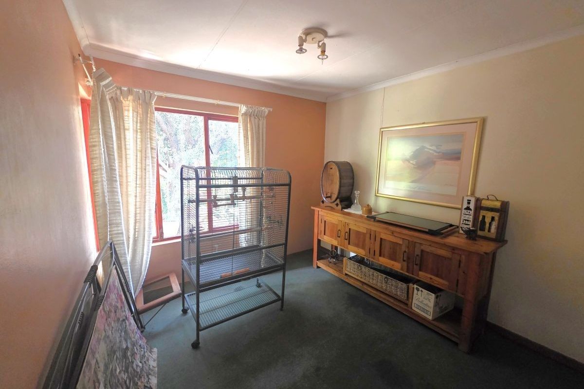 A bedroom featuring dated wall finishes and carpet flooring, offering a blank canvas for potential modernization and interior design updates.