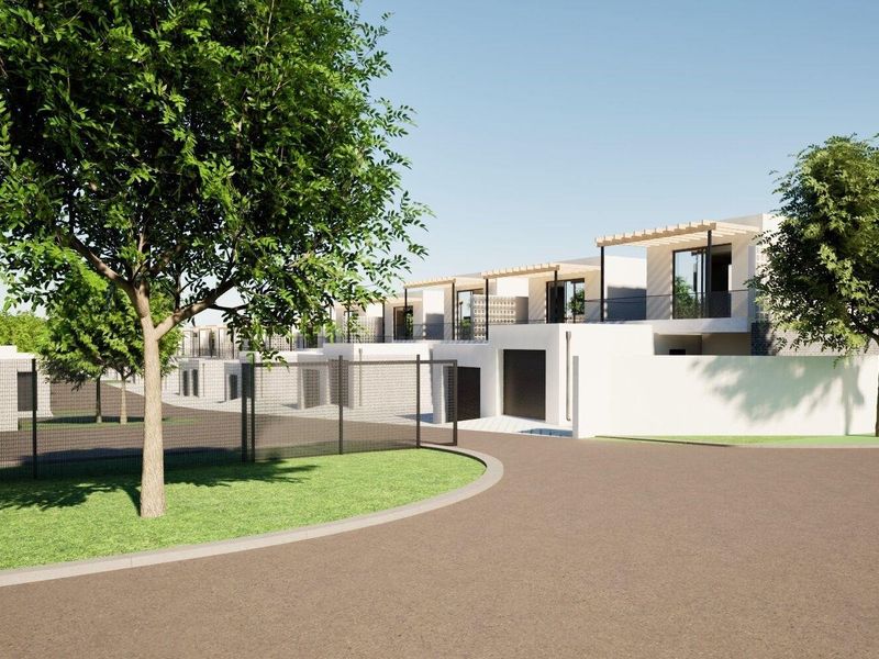 A digital rendering of a modern residential complex featuring paved driveways, private balconies with pergolas, and secure perimeter fencing.