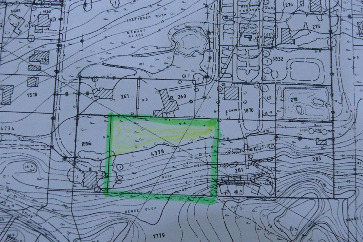 A topographical survey map highlighting a specific residential land plot within the broader site layout.