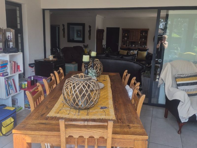 A covered patio area featuring large format floor tiles and sliding glass doors that provide seamless access to the interior living space.