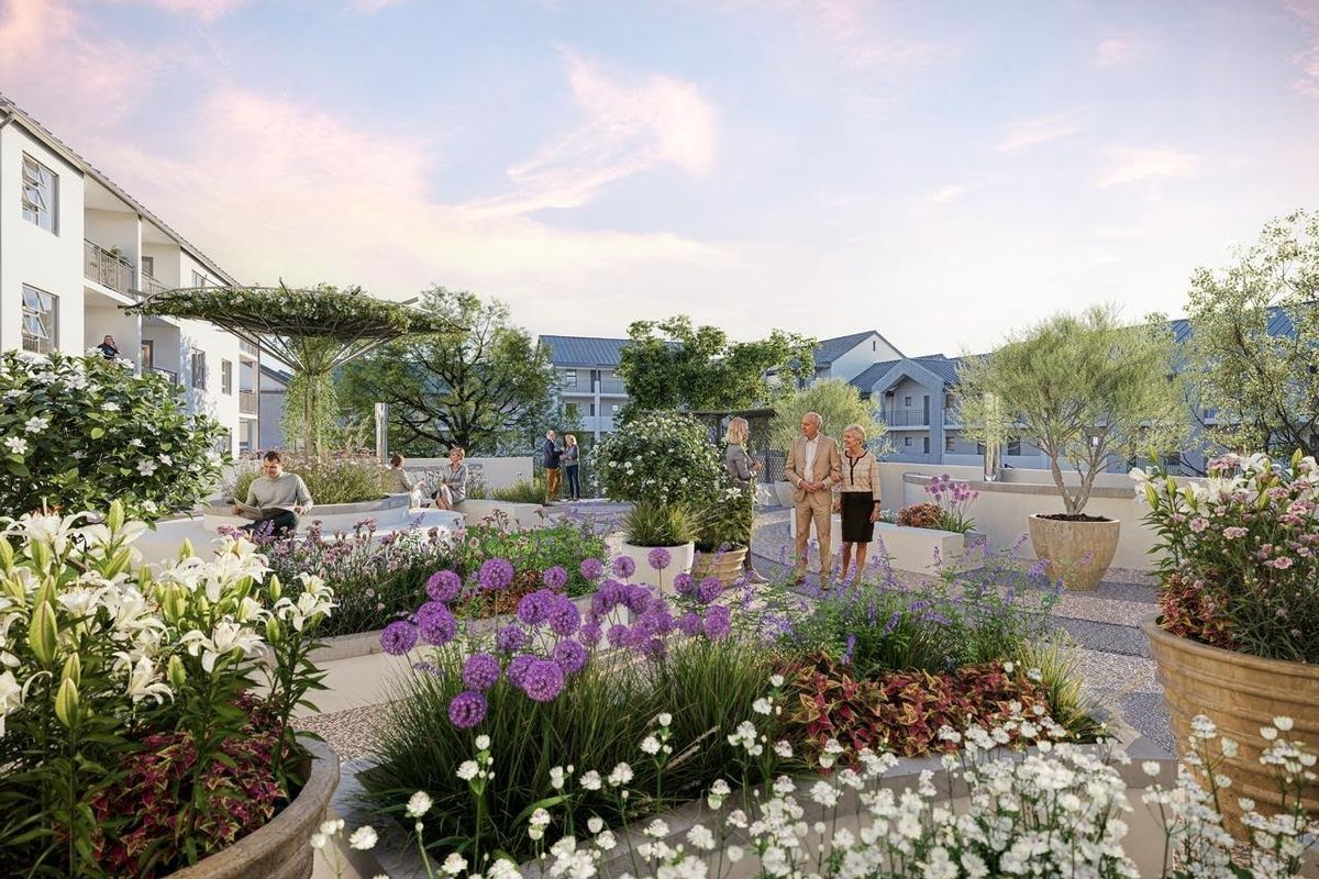 A beautifully landscaped communal garden area featuring raised planters, paved walkways, and a pergola, designed for residents of the retirement village.