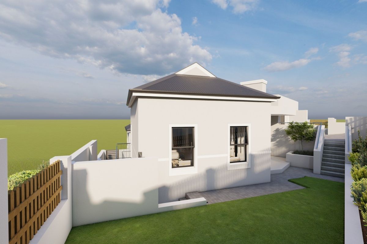 A rear view of a modern house featuring a pitched roof, paved pathways, landscaped garden, and a staircase leading to an elevated outdoor area.