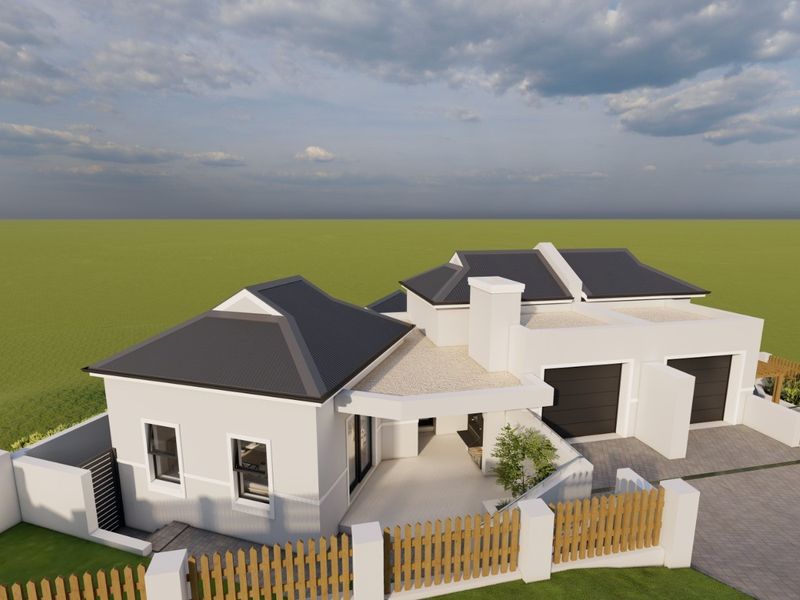 Aerial view of a modern residential house featuring a hipped roof, double garage, paved driveway, and a covered patio area.