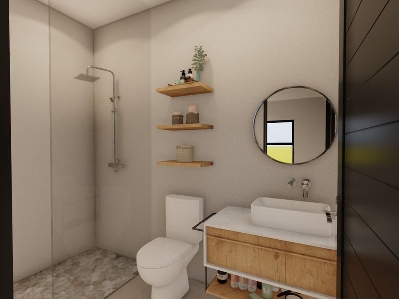 Modern bathroom featuring a walk-in shower with pebble flooring, a sleek vanity with vessel sink, and contemporary wall-mounted fixtures.