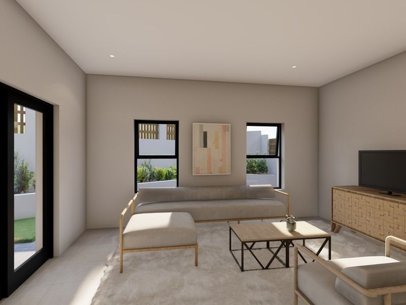 A modern, well-lit living room featuring neutral tones, tiled flooring, and black aluminium framed windows and sliding doors leading to an outdoor area.