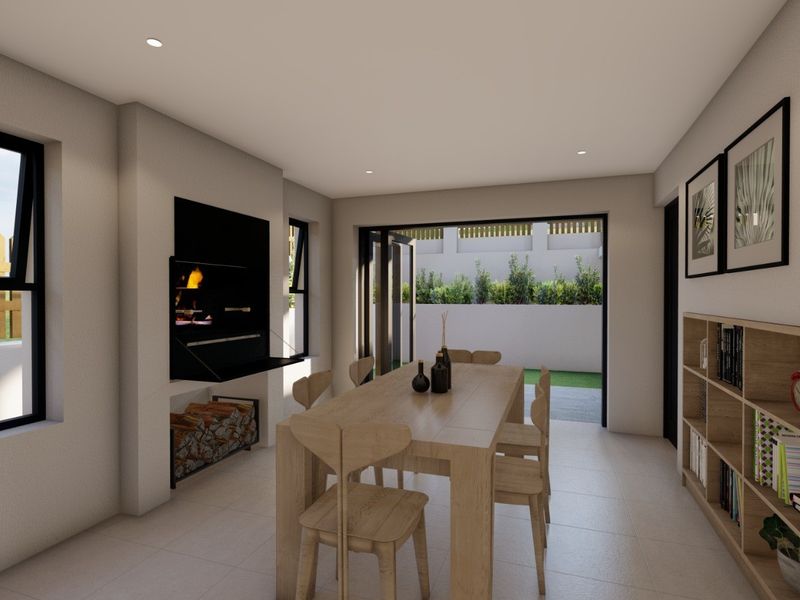 Modern dining area featuring a built-in fireplace, wood storage niche, and large stacking doors that open to an outdoor patio space.
