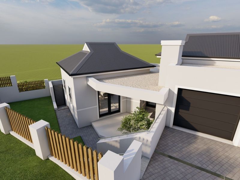 A high-angle view of a modern house exterior featuring a paved driveway, garage, and secure boundary wall with timber fencing.