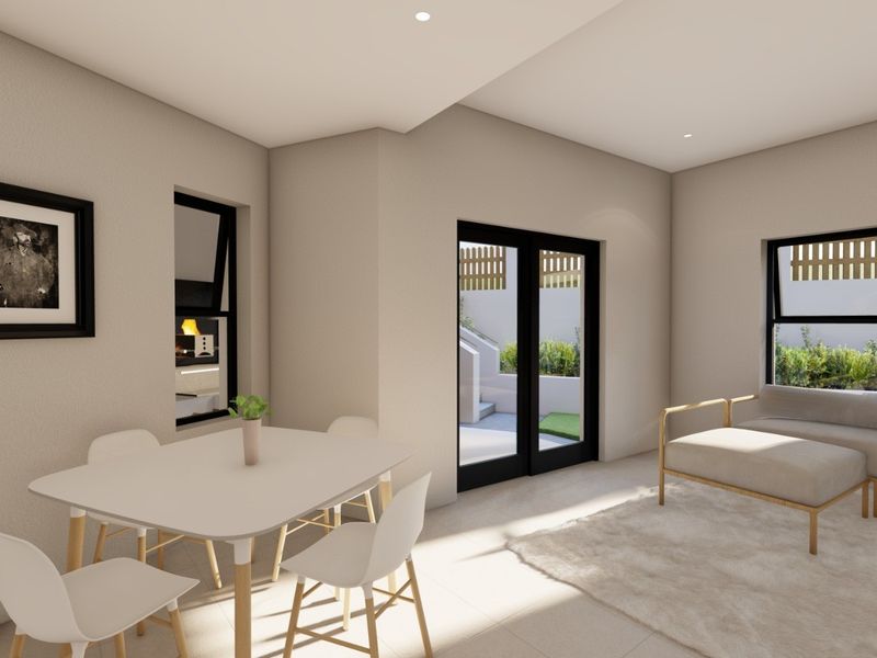 Modern open-plan living and dining area featuring neutral finishes, recessed lighting, and direct access to an outdoor patio through double glass doors.
