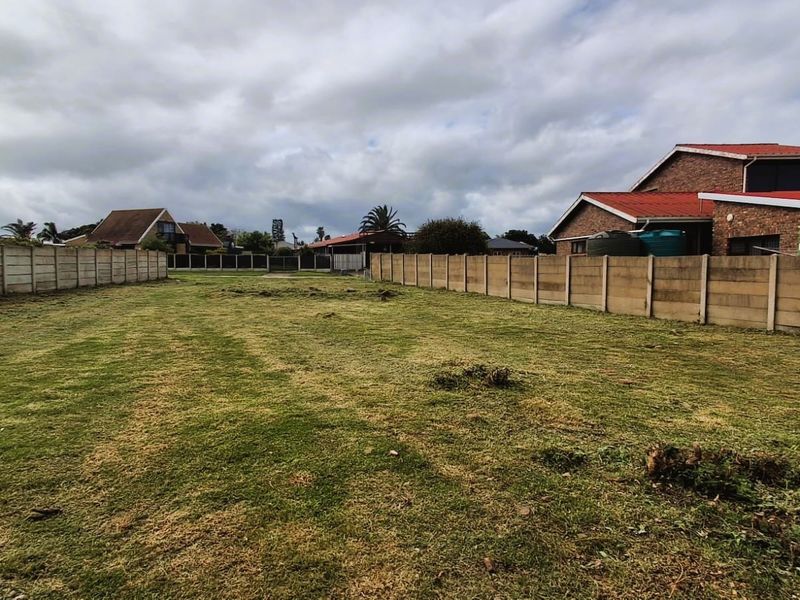A spacious, level residential plot of vacant land enclosed by precast concrete boundary walls, offering a clear area for potential development.