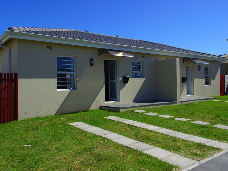 Front view of a well-maintained single-story residential property featuring a tiled roof, concrete driveway, and secure entrance access.