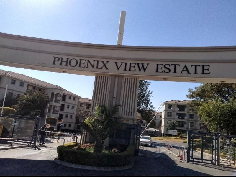 The main entrance gate and security access point for Phoenix View Estate, featuring clear signage and controlled vehicle entry.