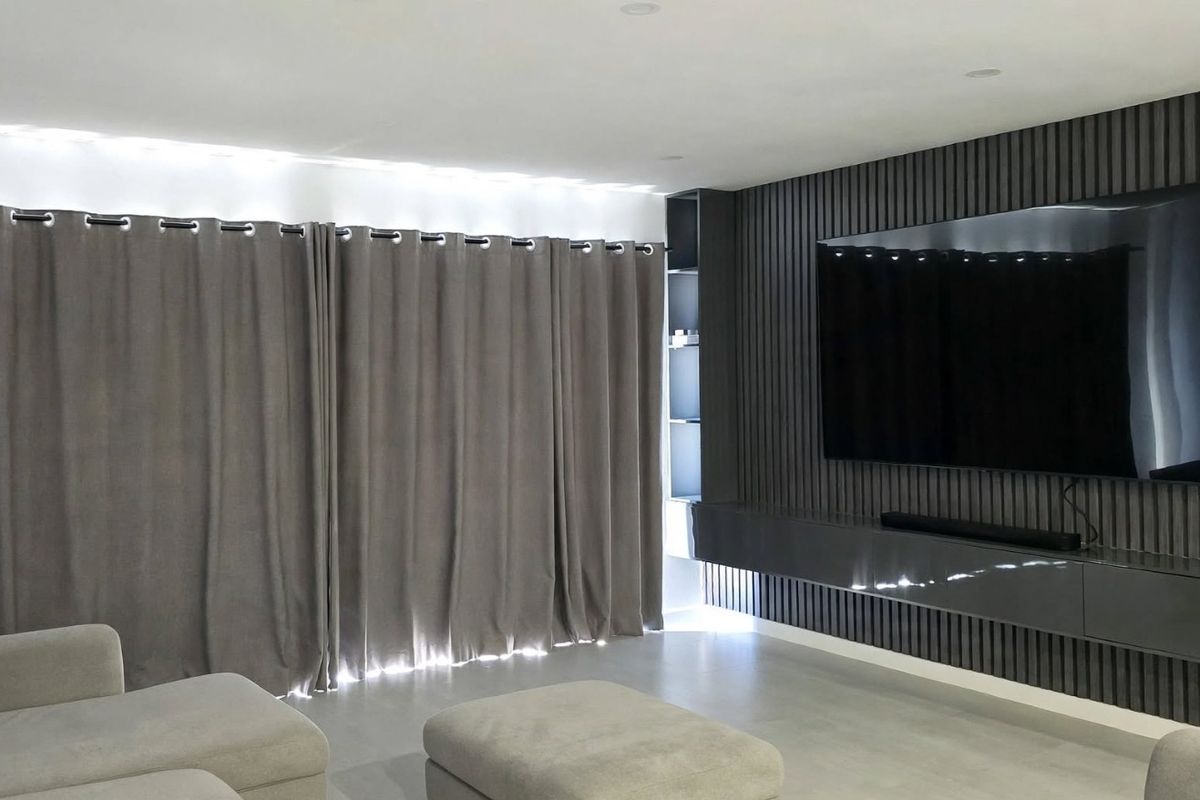 Modern living room featuring a stylish slatted timber feature wall with a built-in floating media console and recessed ceiling lighting.