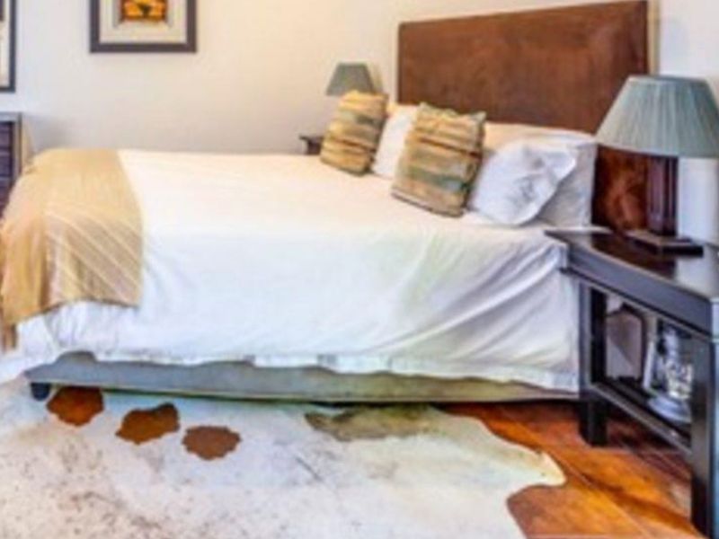 A bedroom featuring hardwood flooring and neutral wall finishes.