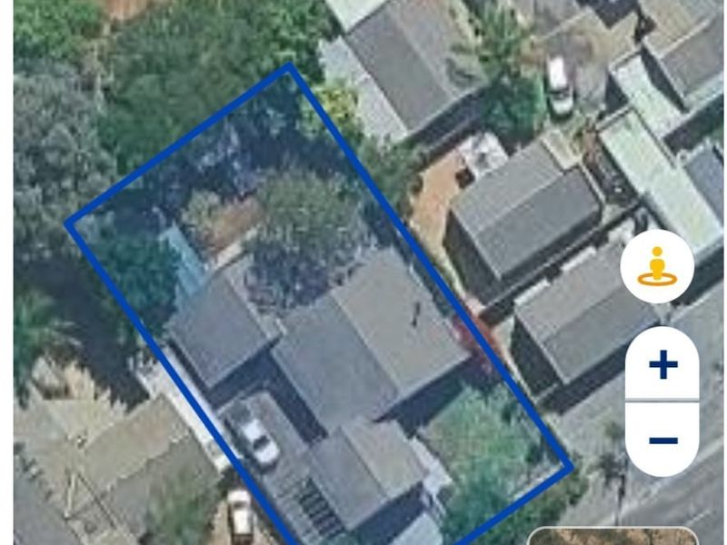 An aerial satellite view showing the property layout, roof structure, and surrounding residential plot.