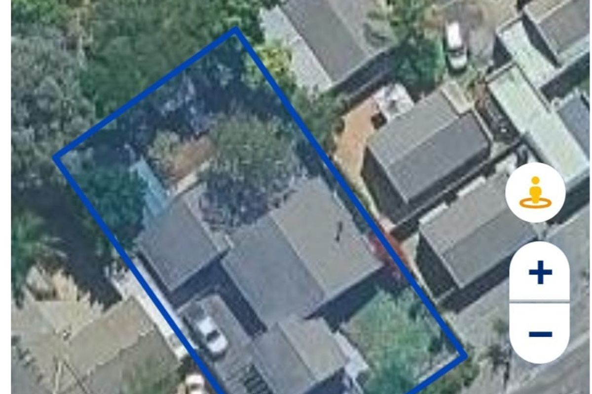 An aerial satellite view showing the property layout, roof structure, and surrounding residential plot.