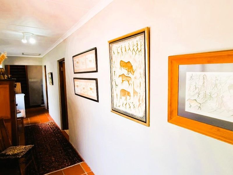 A well-maintained interior hallway featuring tiled flooring and neutral wall finishes, providing access to various rooms within the home.