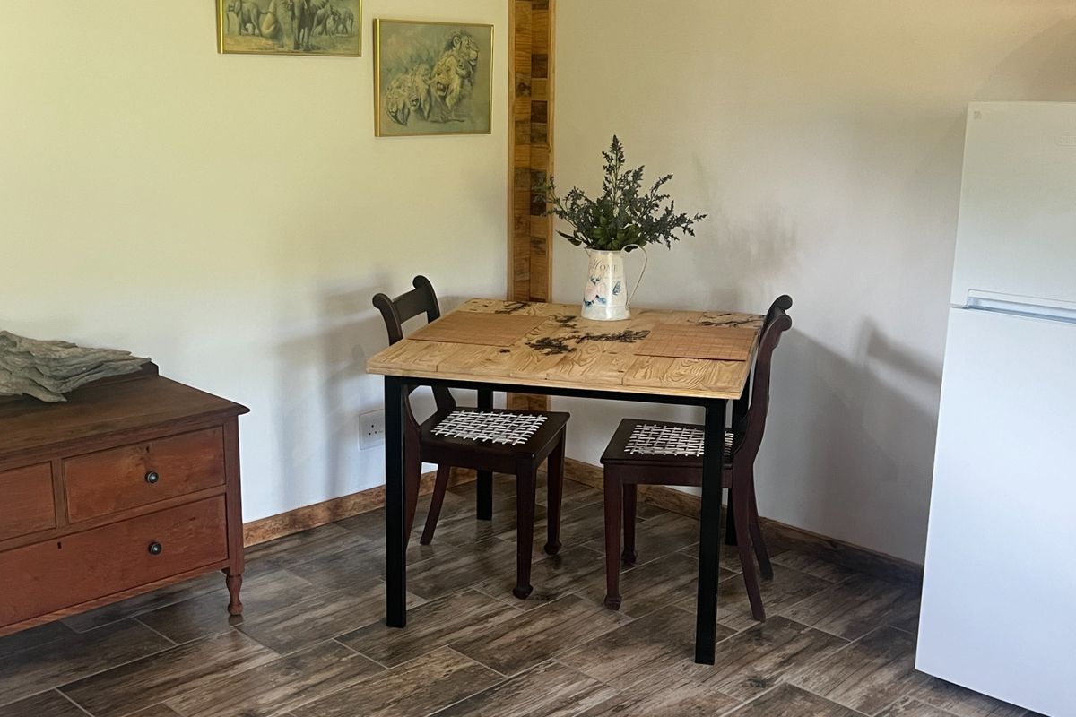 A cozy living area featuring wood-look tile flooring and timber wall accents, providing a warm and rustic atmosphere.