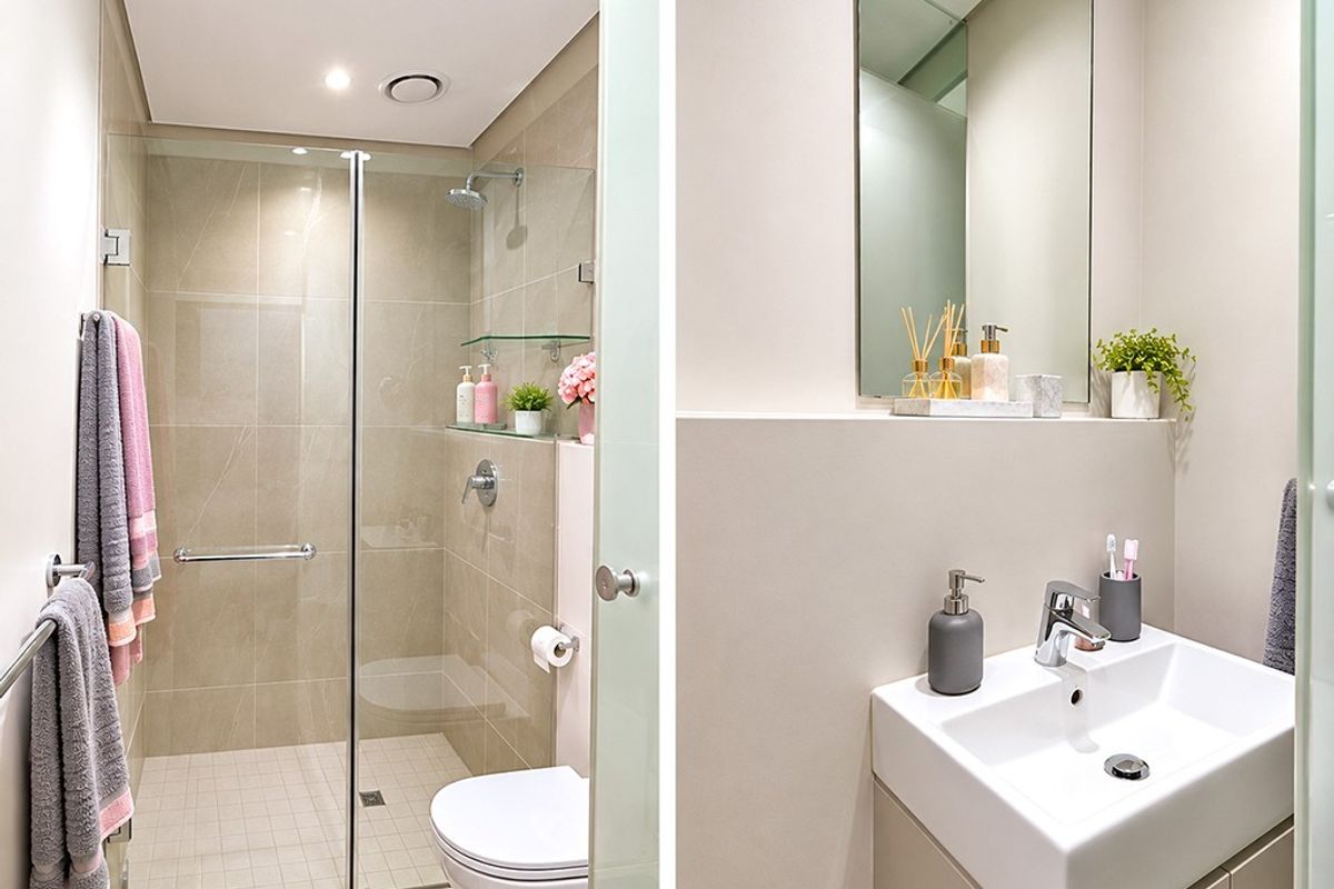 Modern bathroom featuring a walk-in shower with glass screen, wall-mounted toilet, and a sleek vanity unit with basin and mirror.